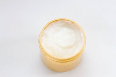 cosmetic face moisturizing white cream for skin in open and golden canの写真素材