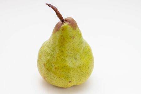 a green ripe pear on a white backgroundの写真素材