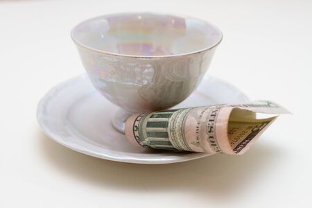 a Close-up of plate with cup and bill tip on white tableの写真素材