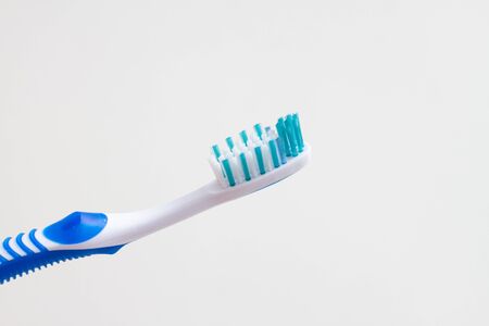 toothbrush with a blue handle on a white backgroundの写真素材