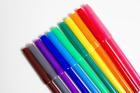 Multi-colored markers for drawing and children's creativity on an white background.