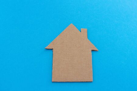 cardboard house sign on a blue backgroundの写真素材