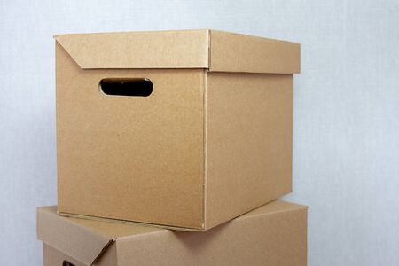 Cardboard boxes on top of each other on a gray backgroundの写真素材