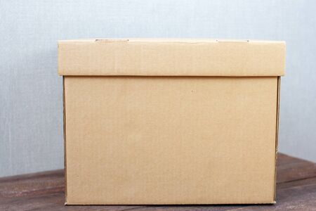 Blank cardboard box blank on wooden background