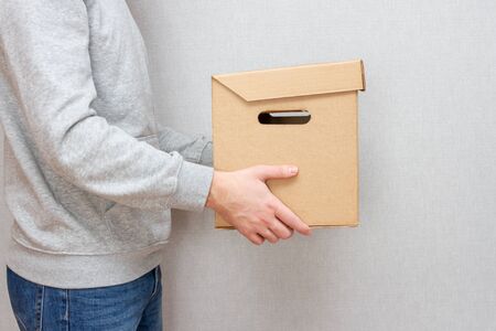 Courier with a parcel in his hands. Delivery concept. a Cardboard box