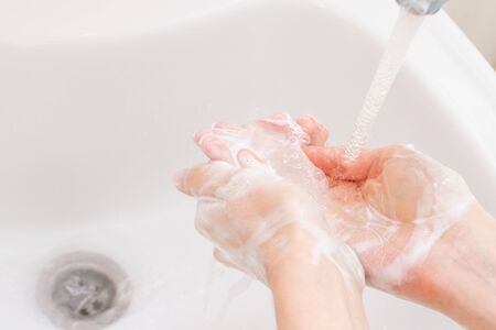 Washing hands with foam. Hygiene concept.の写真素材