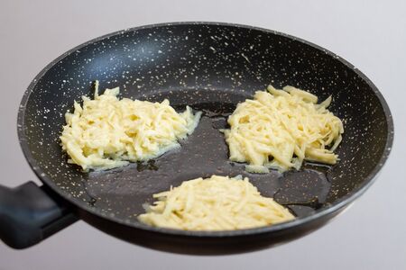 preparation cooking potato pancakes fry in a black pan.の写真素材