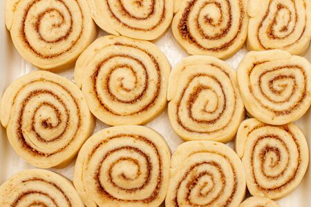 Closeup of cinnamon rolls. Cooks raw buns. Top view.の写真素材