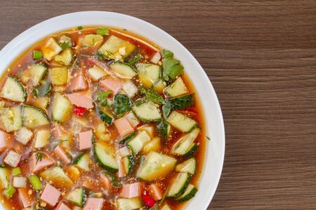 Traditional Russian summer cold soup okroshka with kvass on plate. Top view. Free copy space.の写真素材