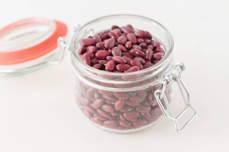 Red beans in a glass jar on a white backgroundの写真素材