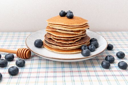 Stack of pancakes healthy breakfast with blueberries on plate in table. Stilllife Healthy breakfast.の写真素材