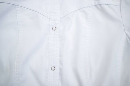 Close up of white medical uniform doctoral or medical coat, clothes.