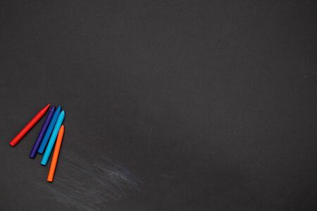 Black board background chalkboard with colored crayons for drawing. Free space.の写真素材
