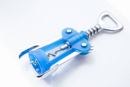 Wine bottle opener. Blue corkscrew for wine on white wooden background.の写真素材