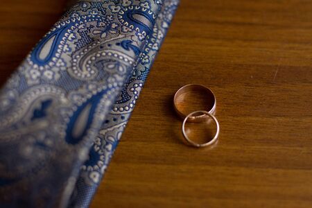 Wedding rings and tie of the groom. Selective focus.の写真素材