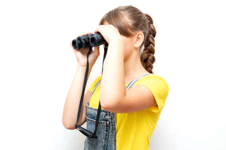 Little child girl looking through binoculars. Adventure conceptの写真素材