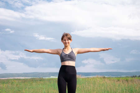 Girl doing sports workout and exercises outdoor in nature