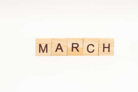 Word MARCH made of wooden blocks on white background. Month of year.の写真素材