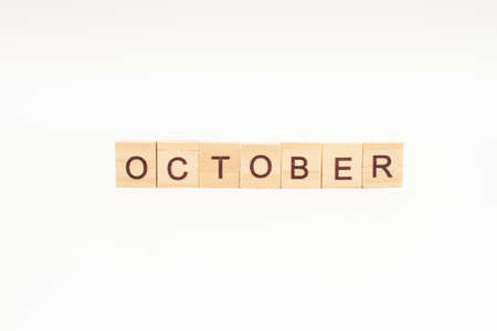 Word OCTOBER made of wooden blocks on white background. Month of year.の写真素材
