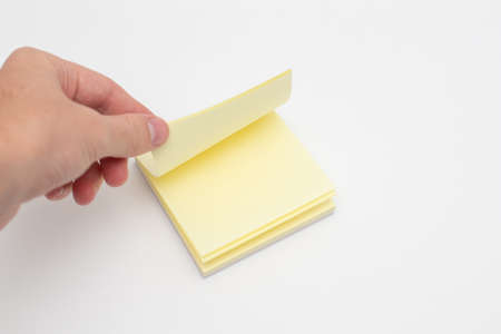 Hand takes a sticker from a stack of colored stickers