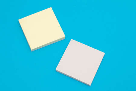Stack of yellow paper stickers on blue background
