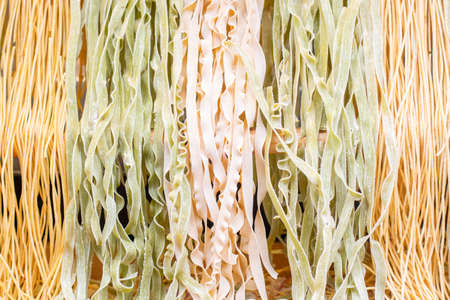 Background different varieties of raw Italian pastaの写真素材