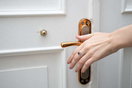 Elegance woman's hand opening vintage door knob.の写真素材