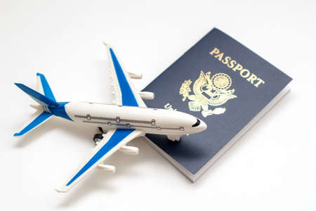 Model plane and US passport. American visa. Travel concept.の写真素材