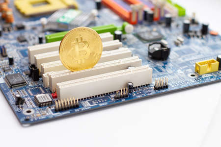 Golden Bitcoin on the circuit main computer board. Cryptocurrency conceptの写真素材