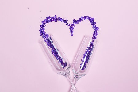 Champagne glass with purple sequins scattered in the form of heart. Valentines Day decorの写真素材