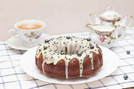 Round Easter homemade cupcake with white icing. Freshly baked homemade protein cream cake, tea set, milk and a cup of cappuccino.の写真素材