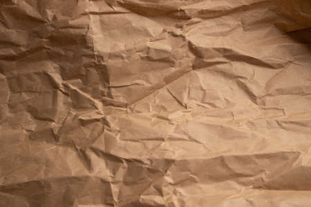 Brown wrinkled kraft paper background. Old cardboard texture backgroundの写真素材