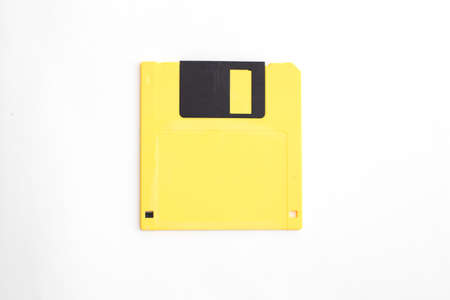 Yellow floppy disk on white background.の写真素材