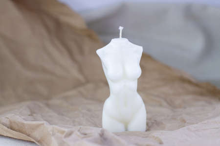 Woman torso hand made candle on craft brown paperの写真素材