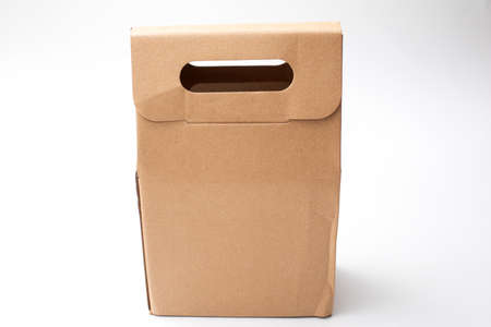 Brown paper bag with handle isolated on white background.