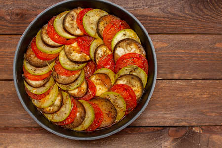 Traditional homemade ratatouille vegetable dish. Ratatouille in frying pan on a wooden tableの写真素材