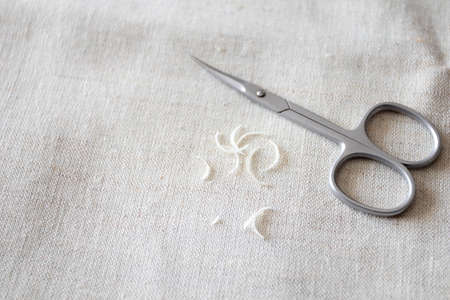Nail scissors and a bunch of clipped human nails.