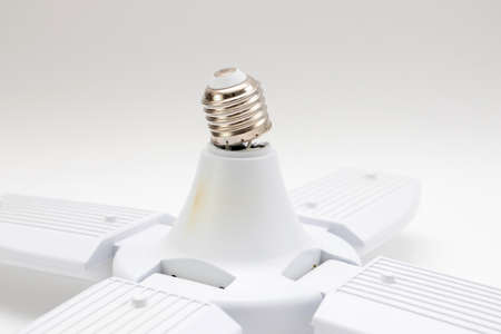 Broken chinese LED bulb lamp isolated on white background. Broken lamp base.