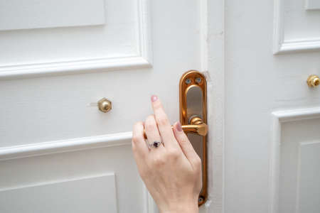 Elegance woman's hand opening vintage door knobの写真素材