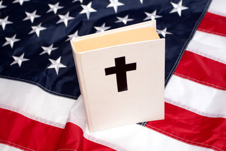 Holy Bible book with a cross on American flag.の写真素材
