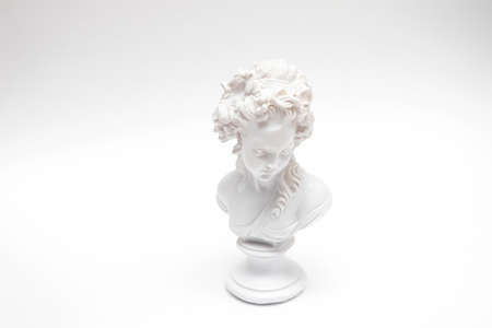 Decorative plaster statuette of a woman head on white background.