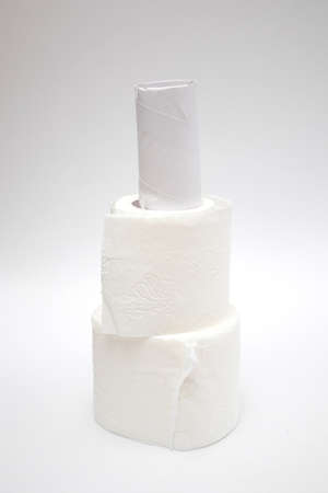 A stack of toilet paper rolls on white background.
