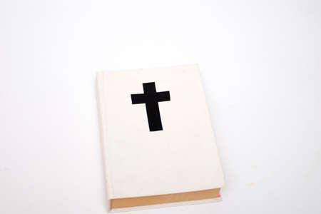 White book with a cross on the cover. Holy Bible book on white background