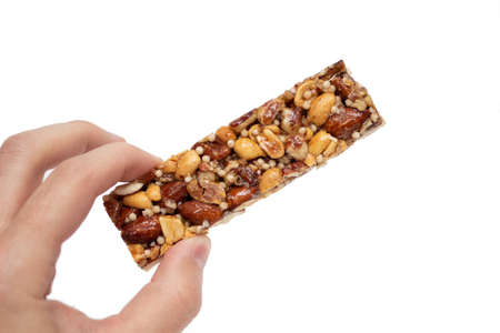 Hand holding nut bar isolated on white backgroundの写真素材