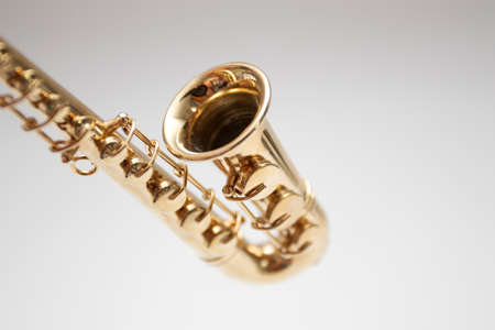 Model of miniature saxophone model on white background.