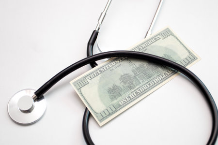 Stethoscope on US Dollars, Medical Care Insurance.