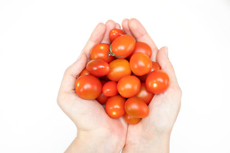 Handful of cherry tomatoes isolated on white background.の写真素材