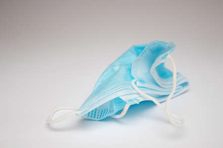 Crumpled medical disposable mask on white background.の写真素材