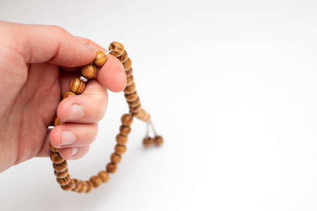 Hand holding a muslim rosary beads.の写真素材