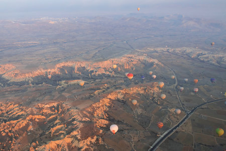 A lot of hot air balloons are flying over the valley in Cappadocia. Aerial photographyの写真素材